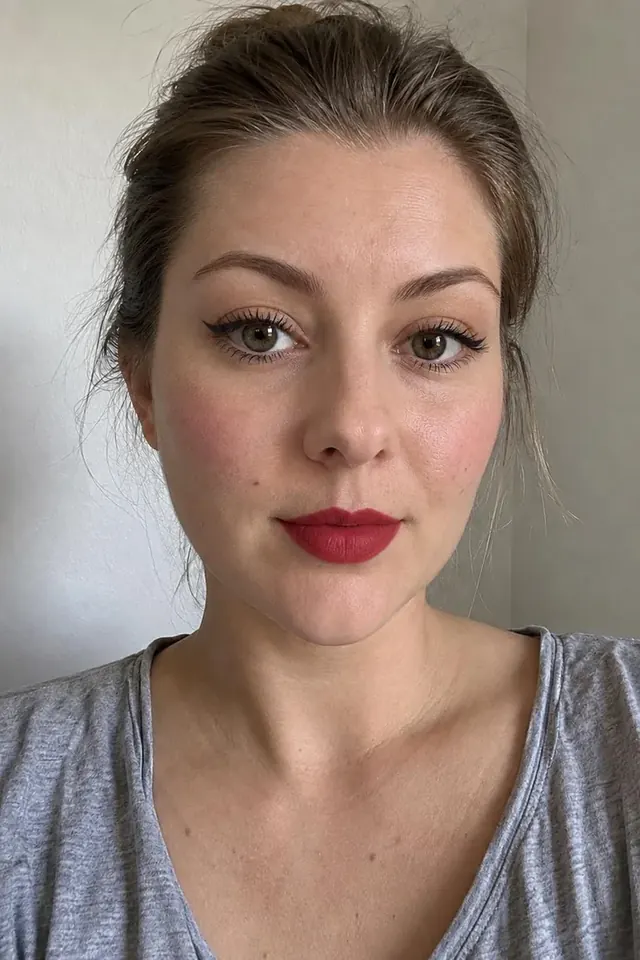 The same woman wearing a classic red lip look